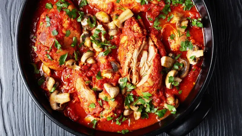 Hot platter of slow-cooked chicken with mushrooms.