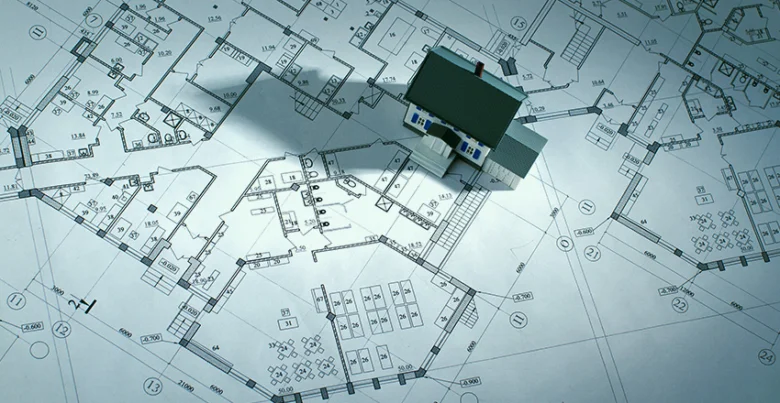 Model domu na architektonických plánech ukazuje zastavěnou plochu.