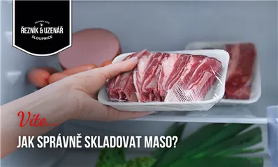 Ruka drží balené maso v lednici s českým textem